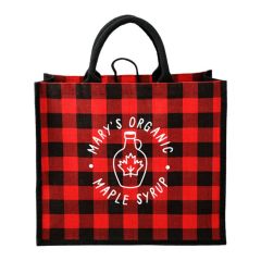 A red and black buffalo plaid tote made from jute. The eco-friendly bag has a white logo on the front.