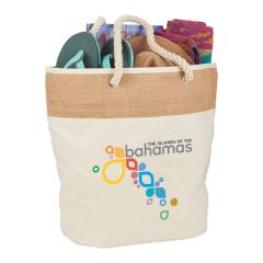 A promotional jute and cotton canvas tote with rope handles. The front has a printed logo and the bag is filled with goods.