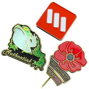 three different shaped lapel pins with different coloured soft enamel